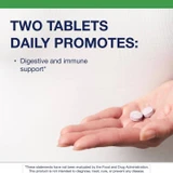 Two UltraFlora Kids chewable tablets in an open hand with suggested use text
