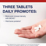 Hand holding three tablets, three tablets daily graphic