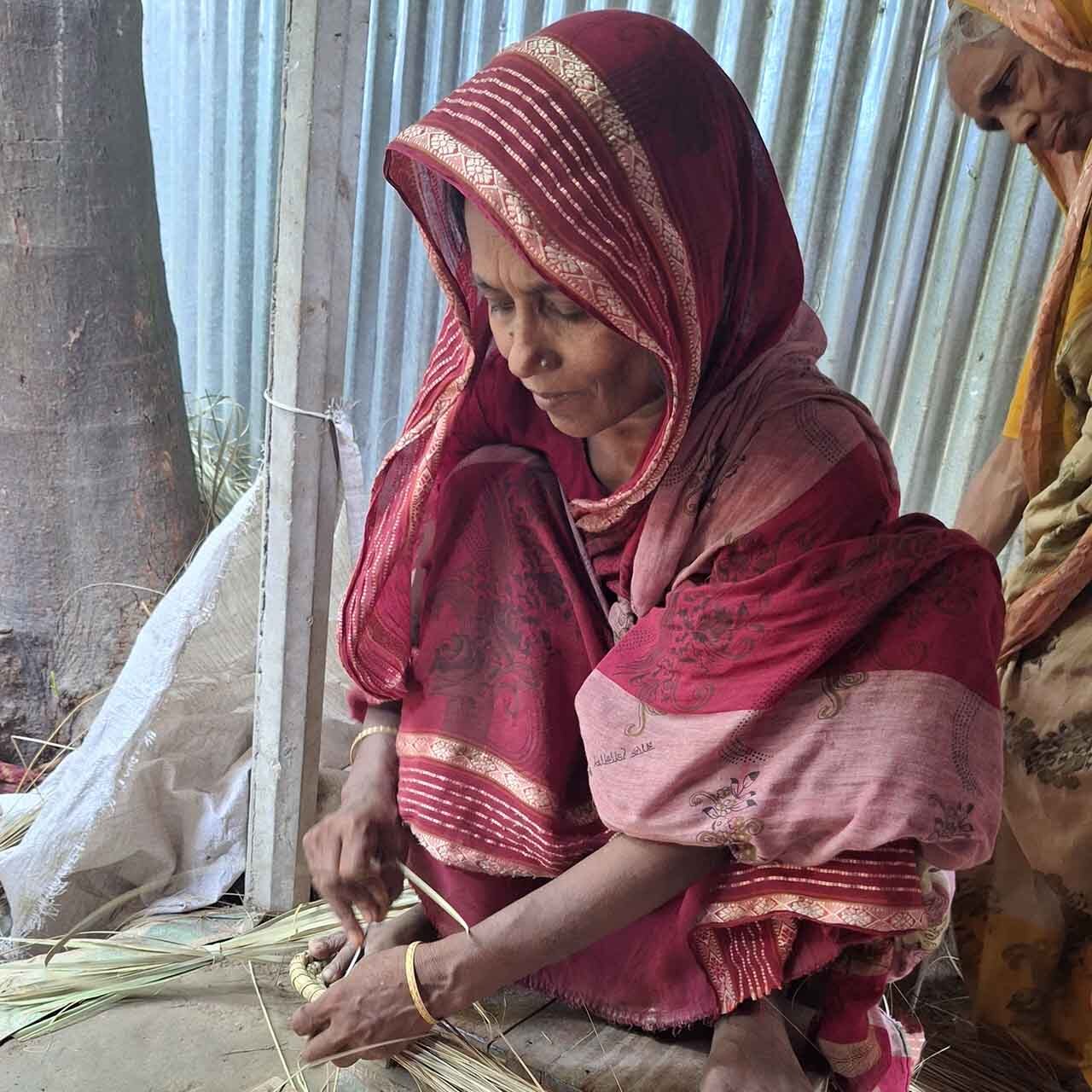 Artisan weaving a bread basket
