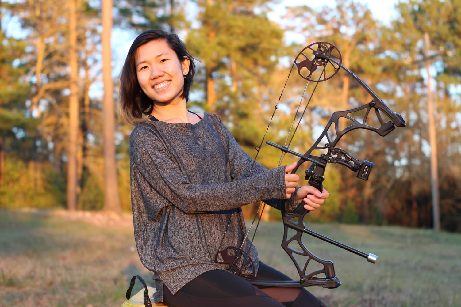 A woman enjoying archery lessons