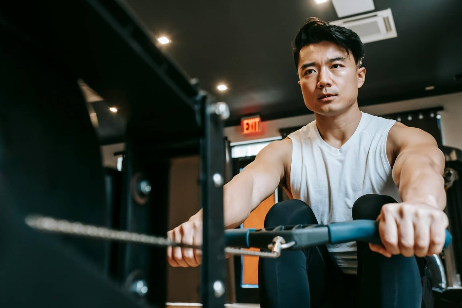 A man doing rowing machine exercises