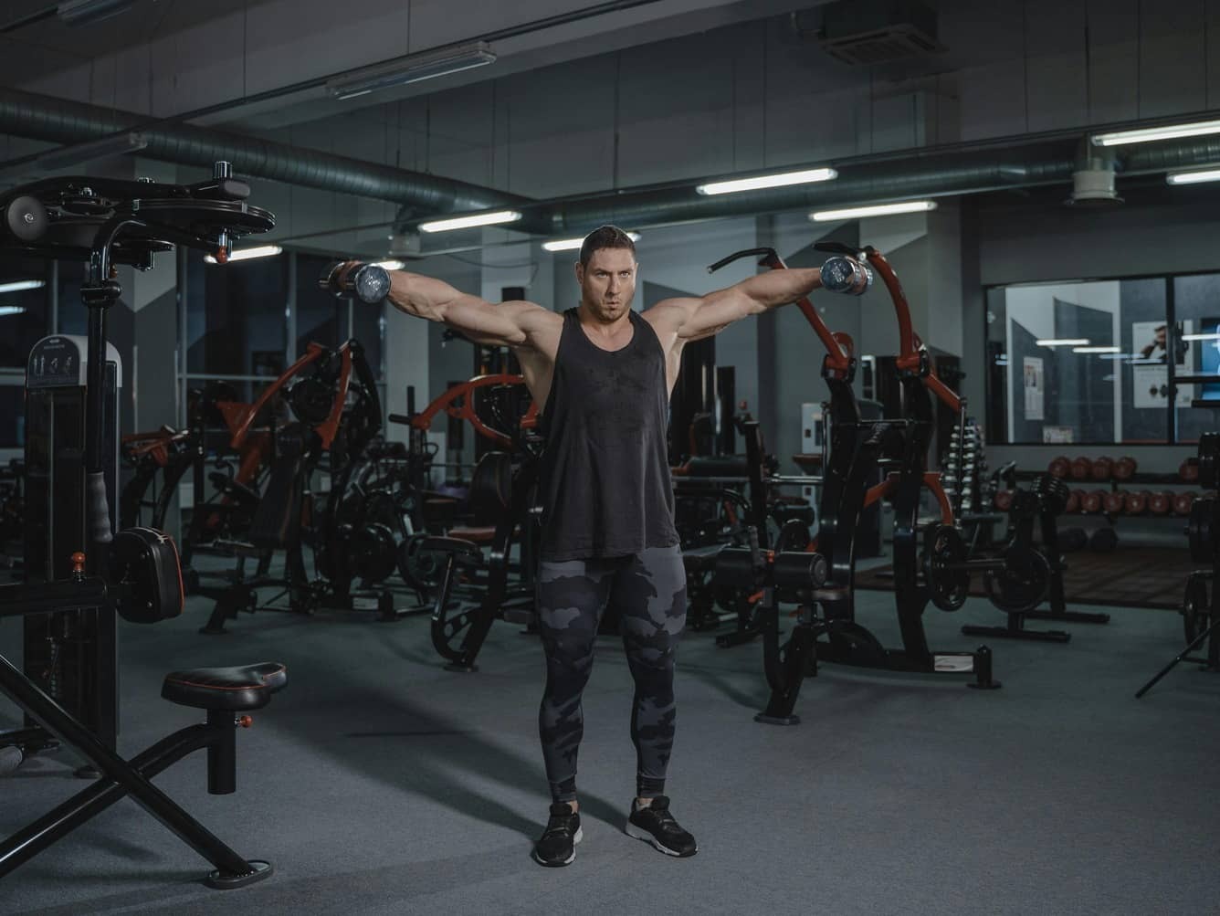 A bodybuilder doing dumbbell side-raises