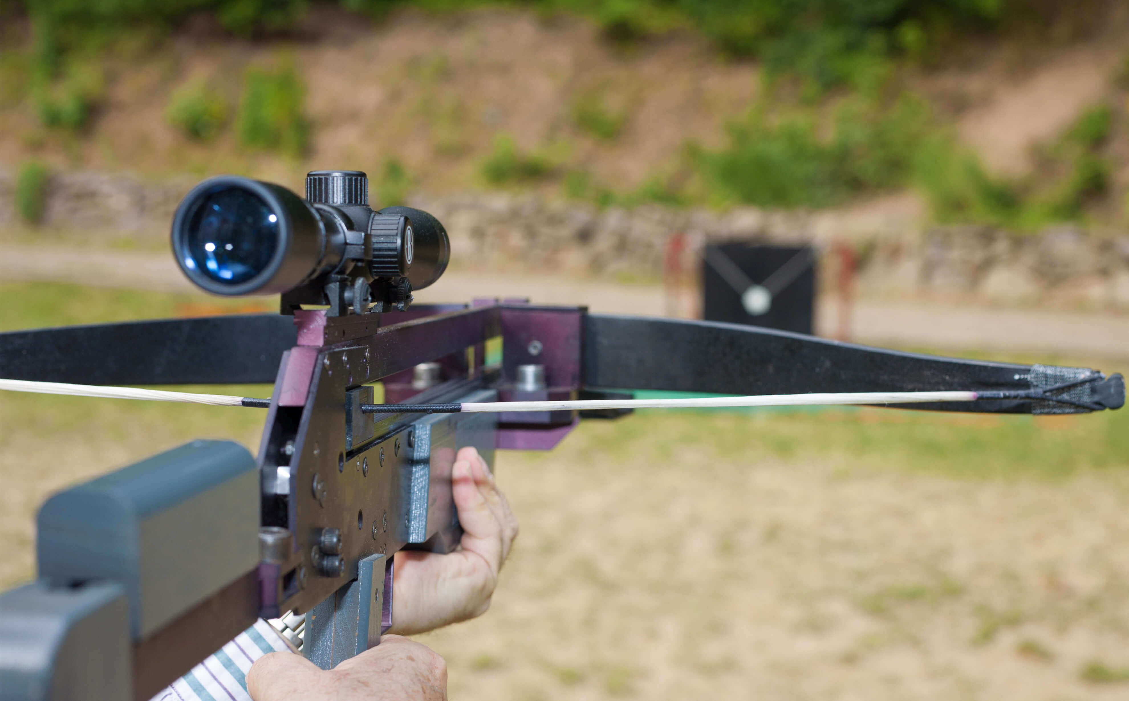 man outside with a recurve crossbow