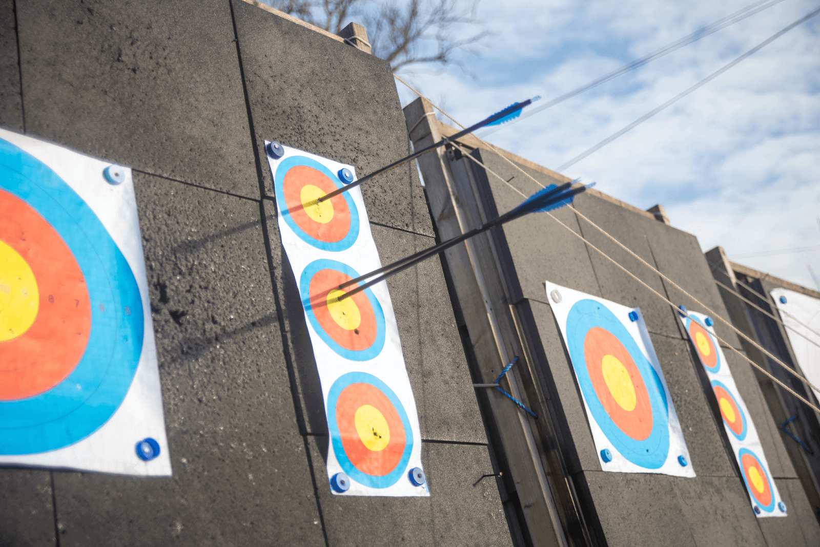 three arrows in small vertical outdoor archery targets