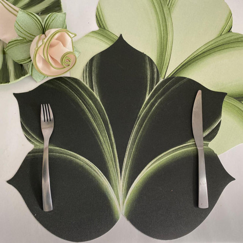 Hosta Leaf Placemat - Pine Frost, a green and black leaf-patterned placemat with cutout leaf shapes, accompanied by a fork and knife, and a fabric flower accessory.
