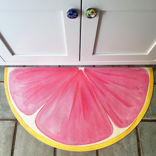 Pink Grapefruit Slice Floor Mat Carole Shiber Designs, colorful half-graphic grapefruit slice floor mat with pink and yellow colors.