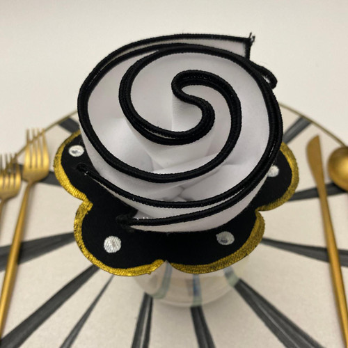Polka-Dot Ring-to-Coaster, white dots on black Carole Shiber Designs, featuring a fabric coaster designed like a ring with white polka dots and a gold and black scalloped border on a decorative surface.