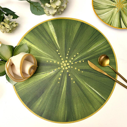 Botanic Leaf Placemat, Pine Carole Shiber Designs with green and yellow leaf pattern and gold trim, set with gold cutlery and decorative elements.