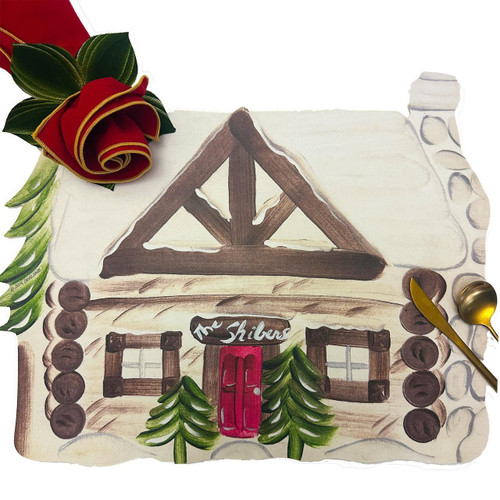 Personalized Winter Cottage Carole Shiber Designs, an illustration of a cozy log cabin decorated for winter with a snowy roof, green pine trees, and a red door.