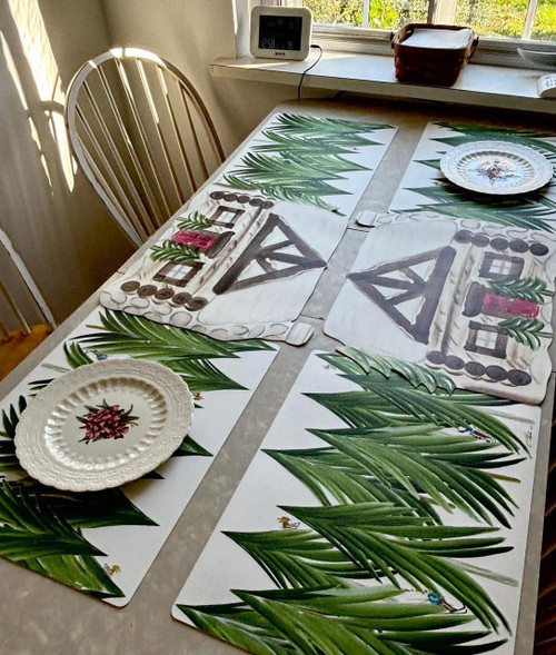 Winter Mountain Village, S/6 Carole Shiber Designs table runner set with green palm leaf pattern and barnyard scene on fabric, displayed on a dining table.