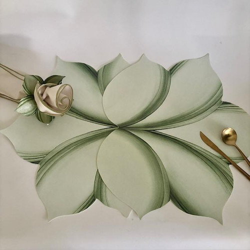 Double Leaf Setting/Centerpiece, elegant table centerpiece with large, overlapping leaf-shaped paper design in light green with dark green accents. Double Leaf Setting/Centerpiece, elegant table centerpiece with large, overlapping leaf-shaped paper design in light green with dark green accents.