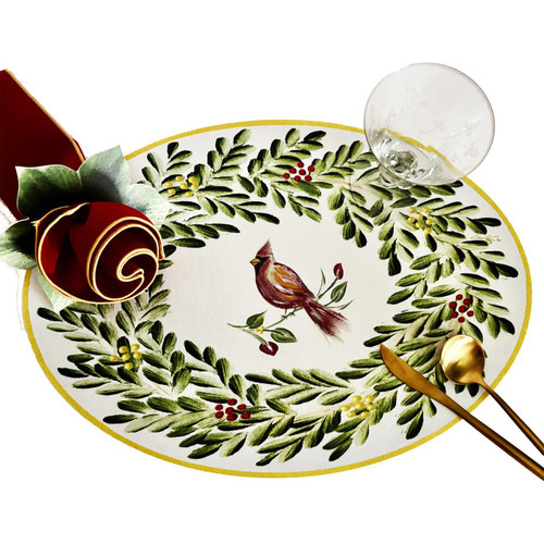 Cardinal in Oval Wreath Placemat by Carole Shiber, decorative holiday placemat with a cardinal bird illustration surrounded by a green wreath and red berries, on a white background.