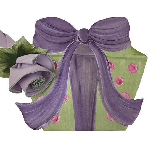 Add a Giftbox Placemat - Green with Lilac Bow by Carole Shiber Designs, featuring a decorative green gift box with pink polka dots, adorned with a large purple bow and a lavender rose.