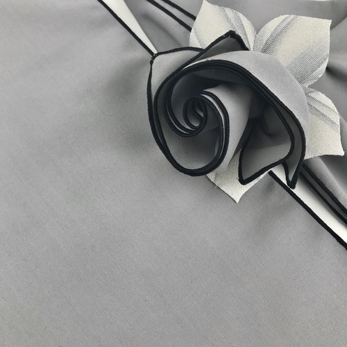 Add a Silver (Grey) Napkins with Black Trim Napkin Carole Shiber Designs, elegant grey napkins with black trim and a decorative flower on a table.