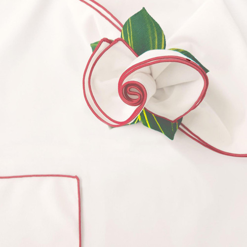 Add a White with Red Trim Napkin, decorated with a floral fabric rosette and green leaves by Carole Shiber Designs.