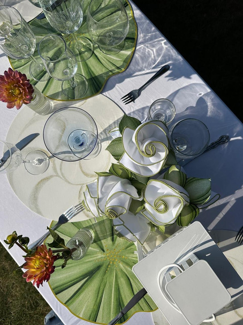 Faith's Rehearsal Dinner Table, elegantly decorated with glassware, floral arrangements, and green and white color theme.