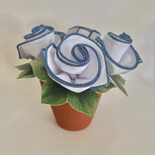 Classic Hydrangea Napkin Bouquet for 4, decorative fabric napkins arranged to resemble hydrangea flowers in a small terracotta pot with green leaf accents.