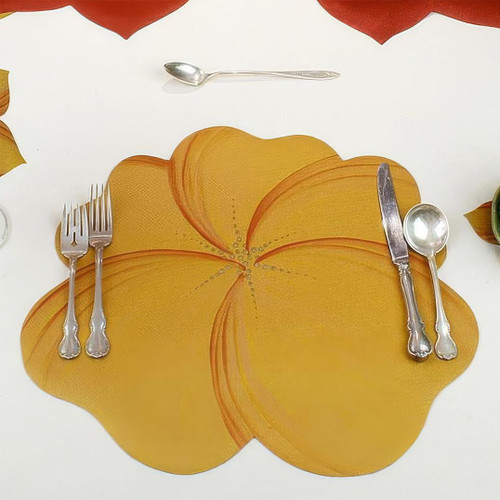 Buttercup Placemat - Gold Carole Shiber Designs, a yellow and gold flower-shaped placemat on a white table setting with silver flatware.