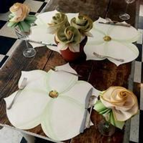 Magnificent Magnolia Mint, elegant table setting with white flower-shaped plates, green accent napkins, and floral centerpiece by Carole Shiber Designs.