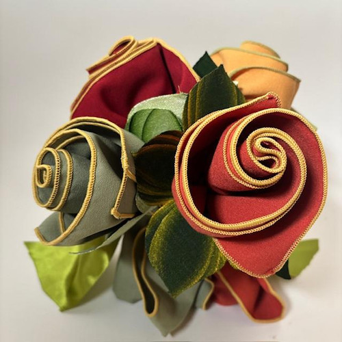 The Earthtone Bouquet, S/4 Carole Shiber Designs, a crafted fabric bouquet with earth-tone roses and leaves, featuring rolled fabric roses in shades of red, green, and beige with yellow trim.