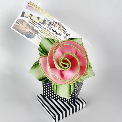 Our $100 Gift Certificate Carole Shiber Designs, decorative gift certificate with a pink satin flower and green ribbon leaves arranged in a black and white polka dot and striped gift box.