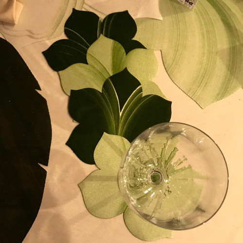 Leaf Coasters, Mint & Pine Set of 4 Carole Shiber Designs, featuring green leaf patterns on fabric coasters with a glass of water on top.