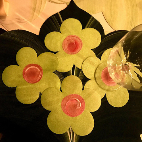 Flower Power Coasters, Set of 4 Carole Shiber Designs, yellow flower-shaped coasters with pink centers arranged on a table.