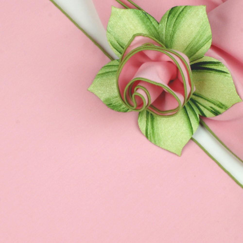 Light Pink with HoneyDew Trim Napkin Carole Shiber Designs, decorative pink napkin with green and pink trim, styled with a green and pink silk flower on pink background.