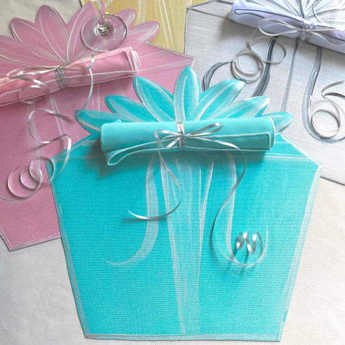 Complete Party of 4 Carole Shiber Designs, colorful table setting with floral-themed placemats, rolled napkins tied with silver ribbons, and elegant silver curl decorations for celebration.