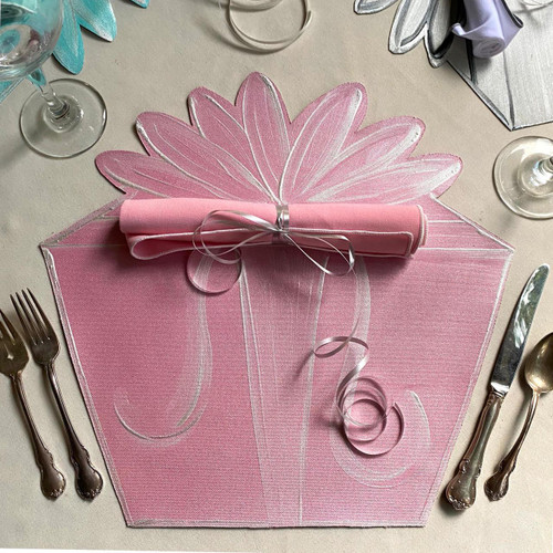 Gift Box Party Pink Placemat Carole Shiber Designs, elegant pink placemat with floral design on a table setting with silverware, glasses, and napkin.