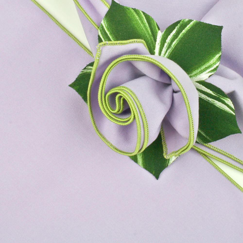 Lilac with HoneyDew Trim Napkin Carole Shiber Designs, a decorative napkin featuring a lavender color with green and yellow floral trim and a rolled and pleated design. Lilac with HoneyDew Trim Napkin Carole Shiber Designs, a decorative napkin featuring a lavender color with green and yellow floral trim and a rolled and pleated design.