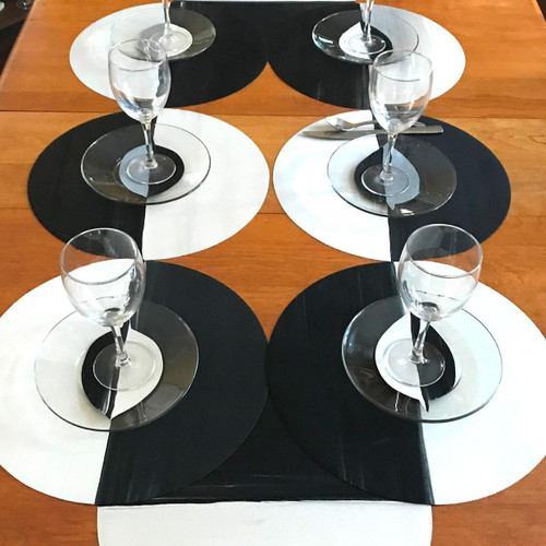 Moonscape 8's Tablescape Carole Shiber Designs, an elegant table setting featuring black and white circular placemats with clear glassware arranged with precision.