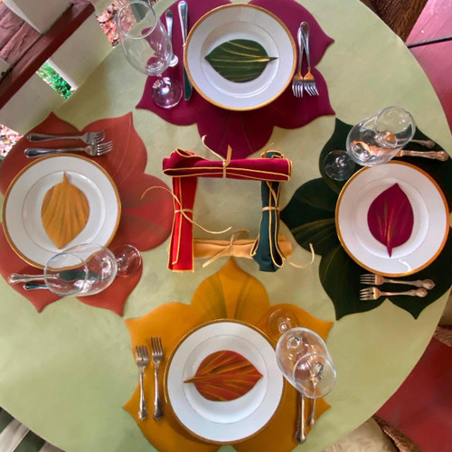 Complete Sweet Leaf Set/4 Carole Shiber Designs, colorful autumn leaf-themed dinnerware with plates, napkins, glasses, and utensils arranged on a table.