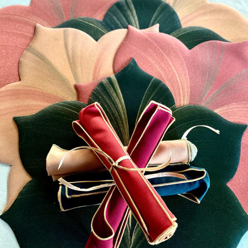 Sweet Fall Mats & Naps, Set/6 Carole Shiber Designs, colorful fabric mats with leaf patterns arranged in a fan shape with rolled and tied fabric pieces in the center. Sweet Fall Mats & Naps, Set/6 Carole Shiber Designs, colorful fabric mats with leaf patterns arranged in a fan shape with rolled and tied fabric pieces in the center.