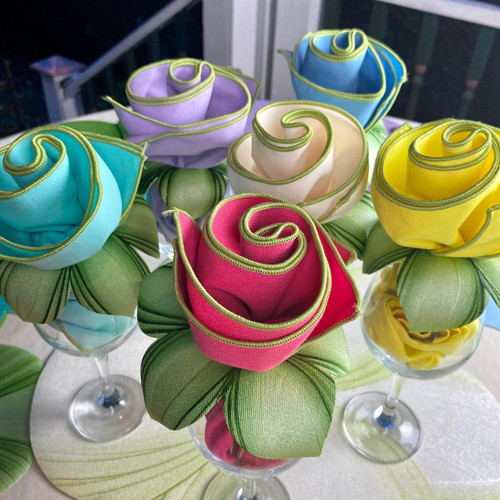 Springtime Bouquet Carole Shiber Designs, colorful fabric roses in pink, yellow, blue, purple, and cream with green leaves arranged in small glass vases.