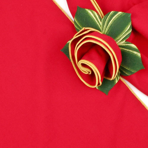 Red with Gold Trim Napkin, ornamental napkin with gold trim and a decorative green leaf embellishment by Carole Shiber Designs.