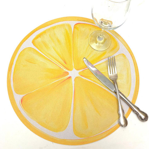 Summer Sale! Lemon Slice Carole Shiber Designs, a colorful lemon slice-shaped table mat with a glass, knife, and fork set on it.