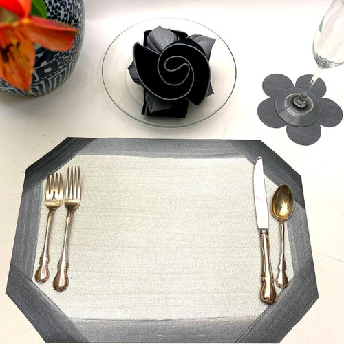 Cutting Corners with Grey on White, Plus Flower Power Coaster Carole Shiber Designs, featuring a table setting with a grey and white placemat, gold utensils, and a black and grey decorative napkin, alongside a flower-shaped coaster and floral extra pieces for decoration.