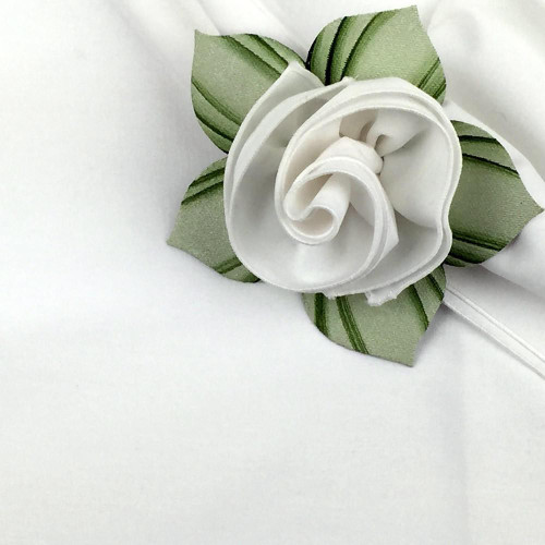 White with White Trim Napkin Carole Shiber Designs, a beautifully crafted white napkin with a delicate floral design and green accented leaves.