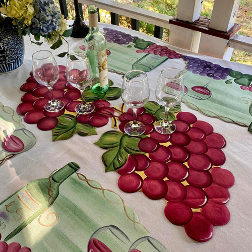 4 Vineyard + Double Grapes Set Carole Shiber Designs, decorative table setting with wine bottles, glasses, and grape-themed table runner.