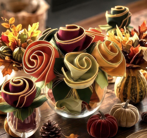 Thanksgiving Bouquet by Carole Shiber Designs, a floral arrangement made of crafted paper roses in fall colors with autumn leaves and small pumpkins.