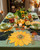 Wild Sunflower Placemat by Carole Shiber Designs, a vibrant yellow sunflower-shaped table place setting with autumn-themed decorations.