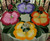 The Complete Pansy Table, colorful table centerpiece featuring artificial pansy flowers in purple, pink, orange, and yellow with green leaves, designed by Carole Shiber Designs.