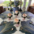 Fall into Thanksgiving Table, Set of 8 Placemats Carole Shiber Designs, elegant dark blue and gold leaf placemats on a round dining table with flower-themed napkin holders and a floral centerpiece.