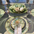 Connecting Leaf Collection Carole Shiber Designs, Elegant table setting with green leaf-themed plates, napkins, and decorative accents for a nature-inspired dining experience.