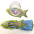 Fish are Jumping! Napkin Ring-to-Coaster Carole Shiber Designs, colorful fish-shaped napkin ring and coaster set with fish pattern, includes a drinking glass on the coaster.
