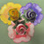 Party Pansy Centerpiece/3 Settings, trio of colorful floral decorations featuring yellow, purple, and pink pansy roses on a green background. Party Pansy Centerpiece/3 Settings, trio of colorful floral decorations featuring yellow, purple, and pink pansy roses on a green background.