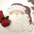 Add a Santa Claus Placemat Carole Shiber Designs, whimsical Christmas-themed placemat with Santa's face, holly leaf, and festive decorations.