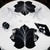 7 Point Leaf - Black/White Carole Shiber Designs, decorative black and white leaf-patterned tablecloth with matching napkins and silverware on a round dining table.