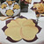 7 Point Leaf - Eggplant/Gold & Bronze by Carole Shiber Designs, decorative table placemats with large gold and bronze leaf pattern on a dark background.